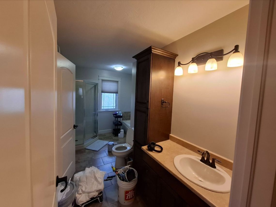 Bathroom walls with a dark wood vanity and white fixtures, a Boss Lady Painting project