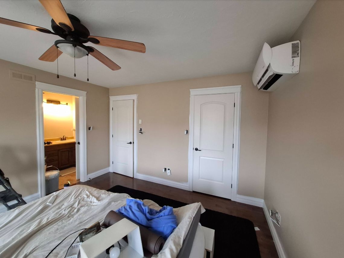 Boss Lady Painting bedroom project with neutral walls and white trim