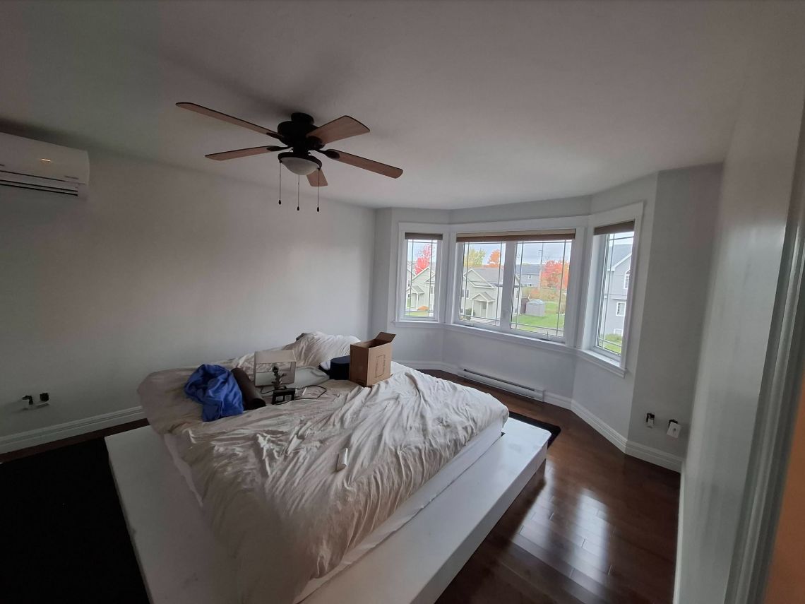 Bedroom with a bay window after painting